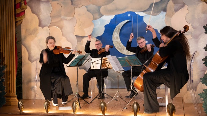 String quartet Aurora Strings performing on the Baroque stage at Seaton Delaval Hall Northumberland for Christmas